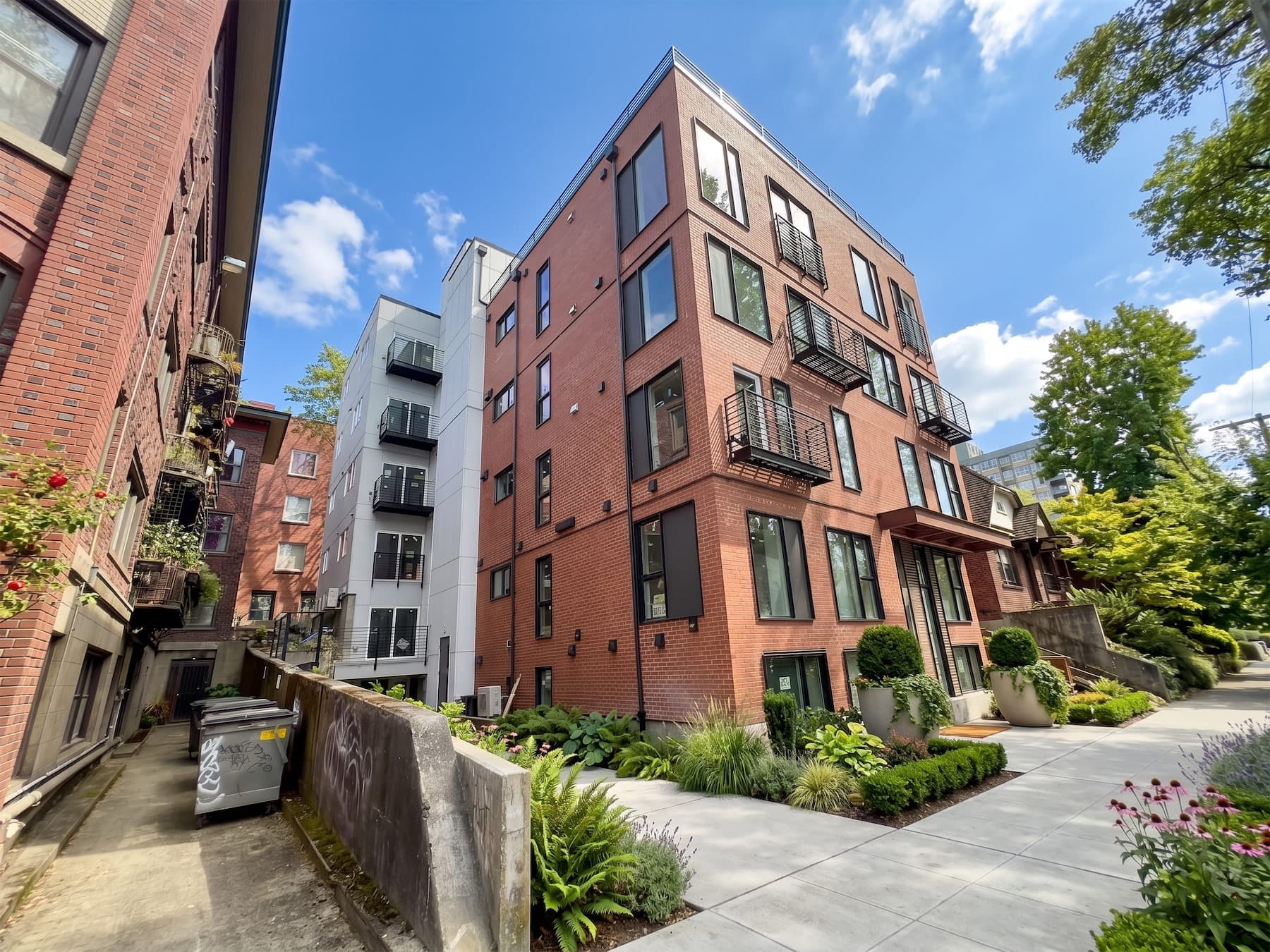 The brick exterior of Thirteen East on 13th Avenue East, graded toward dusk
